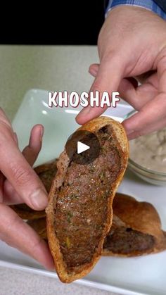 two hands are grabbing something from a sandwich on a white plate with the words khosaf above it