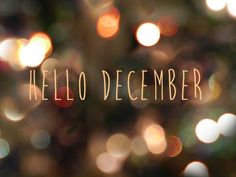 the words hello december are written on a blurry background