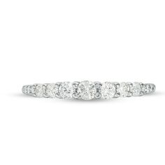 Celebrate your time together with this striking diamond anniversary band. Crafted in 14K white gold, this glamorous design features a ribbon of sparkling diamonds in graduated sizes - with the largest 1/10 ct. diamond dazzling at the center. Radiant with 1/2 ct. t.w. of diamonds and a bright polished shine, this anniversary band is a glittering gift of truest love. Diamond Anniversary Bands, Diamond Anniversary, Anniversary Bands, Sparkle Diamonds, True Love, Design Features, Diamonds, Ribbon, White Gold