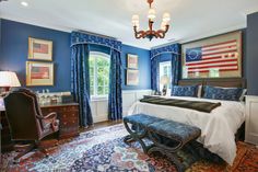 a bedroom with blue walls and an american flag on the wall