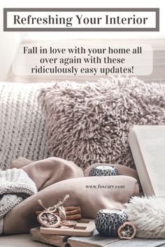 an open book sitting on top of a wooden table next to pillows and other items