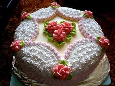 a cake with white frosting and pink flowers on it