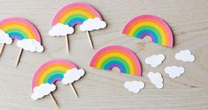 there are rainbows and clouds on the table with toothpicks in front of them