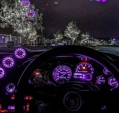 the interior of a car is lit up with purple lights