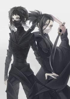 two people dressed in black standing next to each other