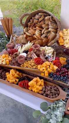 an assortment of cheeses, crackers and other snacks