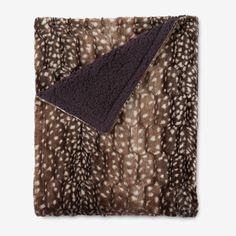 an animal print blanket folded on top of each other