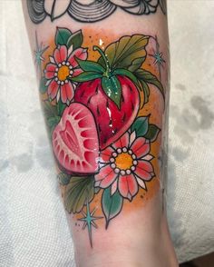 a tattoo with fruit and flowers on it