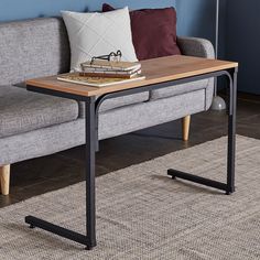 a living room with a gray couch and wooden coffee table on it's side