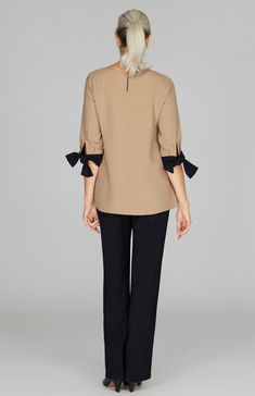 A signature tie cuff style blouse, updated with a deep V inset. Always trimmed in black so it pairs easily with your favorite black pant. Featuring ¾ sleeves and a back neckline keyhole. Elegant 3/4 Sleeve Workwear Blouse, Elegant 3/4 Sleeve Blouse For Work, Elegant Formal Blouse With 3/4 Sleeves, Elegant Tops For Workwear With 3/4 Sleeves, Elegant Top With 3/4 Sleeves For Daywear, Chic 3/4 Sleeve Blouse For Work, Elegant Blouse With 3/4 Sleeves For Daywear, Elegant 3/4 Sleeve Tops For Work, Elegant 3/4 Sleeve Blouse With Button Cuffs