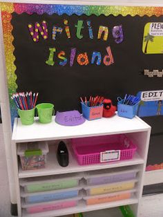 the writing island is filled with books, pencils, and other supplies for students to write