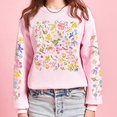 Embrace the timeless elegance of botanical art with our exclusive sweatshirt featuring a colorful flower design remixed from the masterpieces of Pierre-Joseph Redouté. Each petal delicately captures the essence of Redouté's renowned illustrations, blending classic artistry with contemporary style.  Each sweatshirt is carefully crafted to infuse a touch of nature into your wardrobe. The colorful wildflowers burst with life, creating a sense of warmth and joy. This sweatshirt is a perfect blend of style and comfort, making it an ideal addition to your wardrobe. Whether you're going for a walk in the park, a cozy evening in, or simply want to express your love for wildflowers, this sweatshirt has got you covered. Treat yourself or surprise a nature enthusiast in your life with this beautiful Spring Cotton Sweater With Floral Applique, Printed Crew Neck Sweater For Spring, Spring Graphic Print Relaxed Sweater, Embroidered Long Sleeve Sweatshirt For Spring, Pink Casual Sweatshirt With Floral Print, Spring Floral Embroidered Crew Neck Sweatshirt, Spring Cotton Sweatshirt With Floral Embroidery, Pink Floral Print Casual Sweatshirt, Pink Floral Print Sweater For Spring