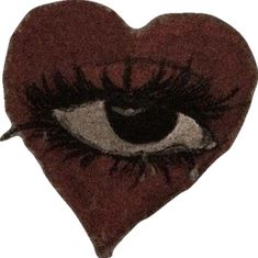 a heart shaped pillow with an eye drawn on it