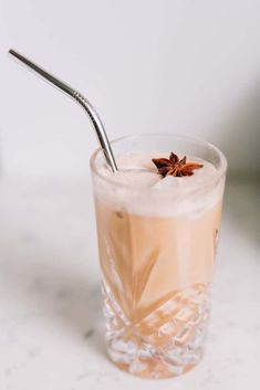 anisette in a glass with ice and cinnamon on the rim, garnished with star aniset