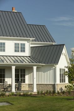 a white house with a black metal roof