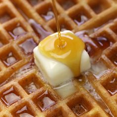 a waffle topped with butter and syrup