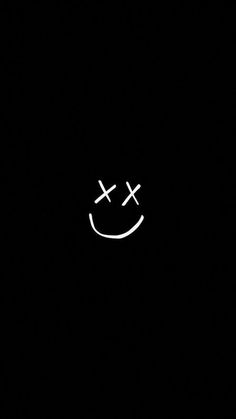 a smiley face drawn in the dark with two crosses on it's forehead and eyes closed