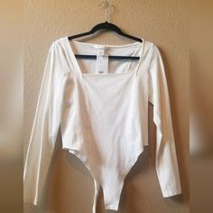 H&M Cream/White Long Sleeve Body Suite Size: M Condition: New Excellent Condition H&m White Tops For Spring, Stretch Off White Top For Spring, Off White Stretch Tops For Spring, Stretch Off White Tops For Spring, Spring Stretch Off White Tops, Fitted Off White Cotton Top, White Long Sleeve Top From H&m, H&m White Long Sleeve Top, Casual White Top From H&m