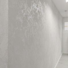 an empty hallway with white walls and floor