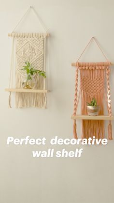 two macrame wall hangings with plants in them on wooden shelves against a white wall