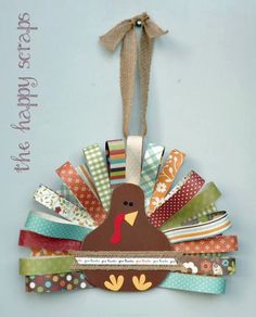 a turkey ornament hanging on a wall with ribbons and ribbon around it's neck