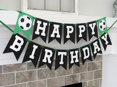 a happy birthday banner with soccer balls on it