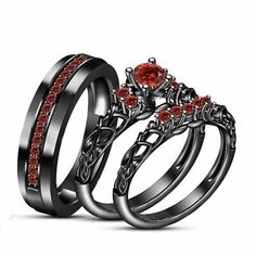 two wedding rings with red stones on each one and an engagement ring in the middle