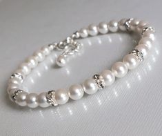 Wedding White Pearl Silver One Strand Dainty Classic Bridal Bracelet. PLEASE READ ITEM DESCRIPTION before placing your order, and contact me with any questions! BRACELET is about 7.25 inches (18.4cm) long plus 1 inch extender chain. BRIDAL BRACELETS SECTION: https://www.etsy.com/shop/LanaChayka?ref=seller-platform-mcnav&section_id=11638942 BRIDAL EARRINGS SECTION: https://www.etsy.com/shop/LanaChayka?ref=seller-platform-mcnav§ion_id=11638940 BRIDAL JEWELRY SETS SECTION: https://www.etsy.com/shop/LanaChayka?ref=seller-platform-mcnav§ion_id=25839214 BRIDAL NECKLACES SECTION: https://www.etsy.com/shop/LanaChayka?ref=seller-platform-mcnav§ion_id=11638944 Elegant and timeless, this bracelet is perfect for weddings or special occasions such as birthdays, anniversaries, graduations, proms...or wh Wedding Pearl Jewelry, Bridal Bracelets, Bridal Necklaces, Pearl Bracelet Wedding, White Pearl Bracelet, Wedding Bracelets, Pearl Jewelry Wedding, Bracelet Wedding, Pearl Bridal