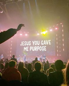 a group of people standing on top of a stage under a large screen with the words jesus you gave me purpose