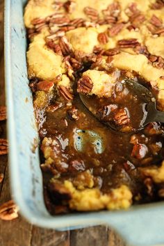 a blue casserole dish filled with pecan pie