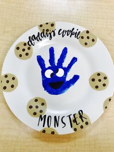 a paper plate with a handprinted blue monster on it that says across the circle