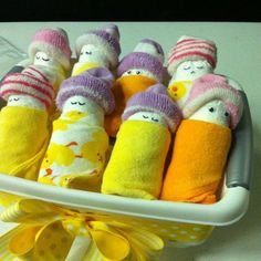 a basket filled with baby doll wrapped in yellow and pink