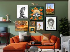 a living room with orange couches and pictures on the wall above it's coffee table