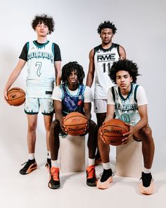 three basketball players are posing for a photo