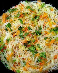 a close up of a plate of food with noodles and vegetables