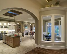 a living room filled with furniture and a kitchen