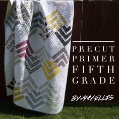 a quilt hanging on a fence with the words precut primer fifth grade written below it