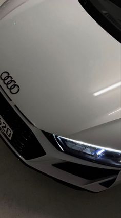 the front end of an audi car in a garage