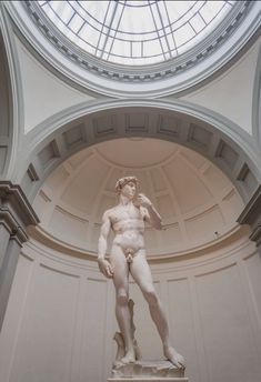 there is a statue in the middle of this room with a skylight above it