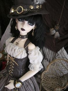 a doll is wearing a dress and hat