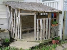 a small wooden shed sitting on the side of a house