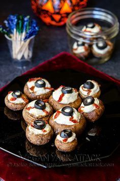 small stuffed mushrooms with black olives and cream cheese on them are ready to be eaten