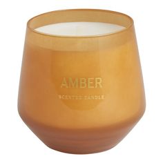 an orange glass candle with the word amber printed on it's front and side