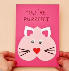 someone holding up a pink card with a cat on it that says, you're purrfect