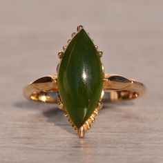 The 62nd Avenue: Mid Century Jade Ring In Yellow Gold. This Ring Showcases A Central Navette-Shaped Cabochon Nephrite Jade, Complemented By A Surrounding Yellow Gold Pattern That Enhances The Overall Design. Crafted In Yellow Gold, The Ring Is Currently Sized At 6.25 But Can Be Adjusted To Any Finger Size For An Additional Charge Upon Request, Ensuring A Personalized And Perfect Fit. Yellow Gold Color, Nephrite Jade, Jade Ring, Gold Pattern, Womens Jewelry Rings, Gold Color, Jade, Perfect Fit, Mid Century