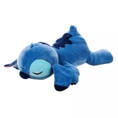 a blue stuffed animal laying on its side