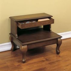 a small wooden table with two drawers on it