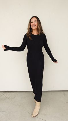 Classic long sleeve black maxi dress with wide rib/pleating detail Stretch knit material Crew neckline Subtle flare at wrists Subtle tie around back Bump friendly Wear on its own, or pair with a jacket or sleeveless vest Runs true to size with stretch. Elizabeth and Lauren both wearing the size small