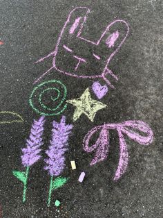 a chalk drawing of a child's car and flowers on the pavement with crayons