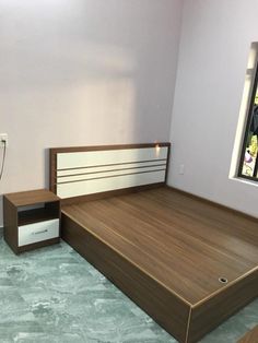 a bed room with a neatly made bed next to a window